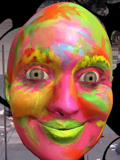 The painted 3D head in front of the live street cam, partly covered by oil