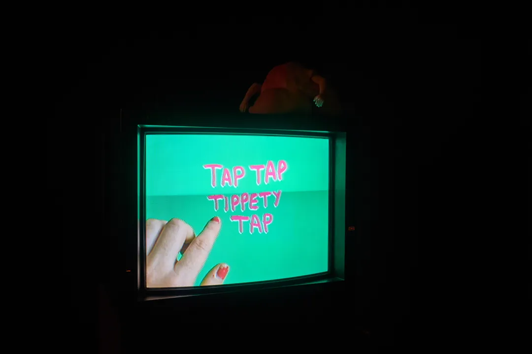 The Tap Tap Tipety Tap screen glowing in the dark, a finger tapping
